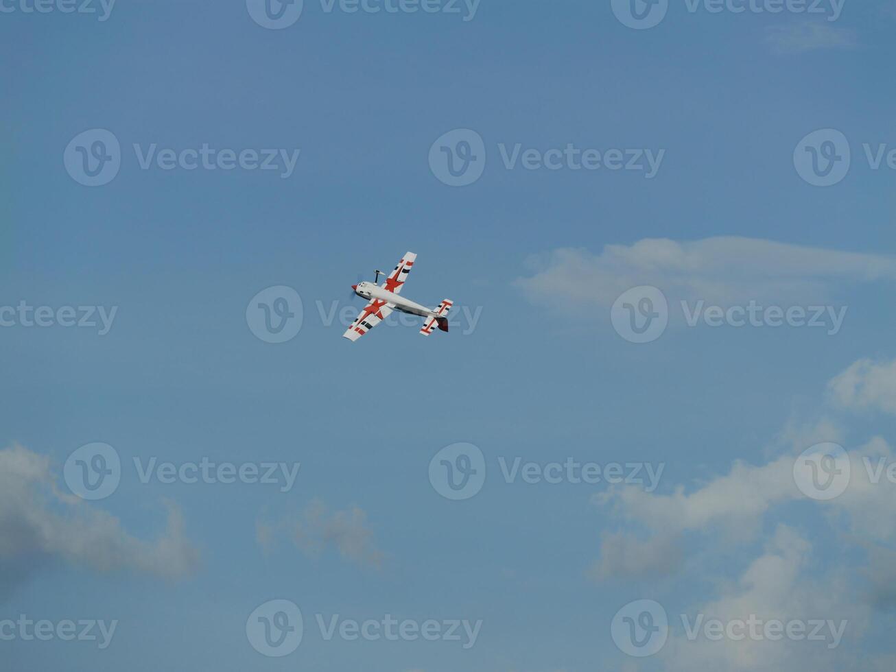 Aerial maneuver of a stunt plane open sky photography daytime high angle aviation excitement photo