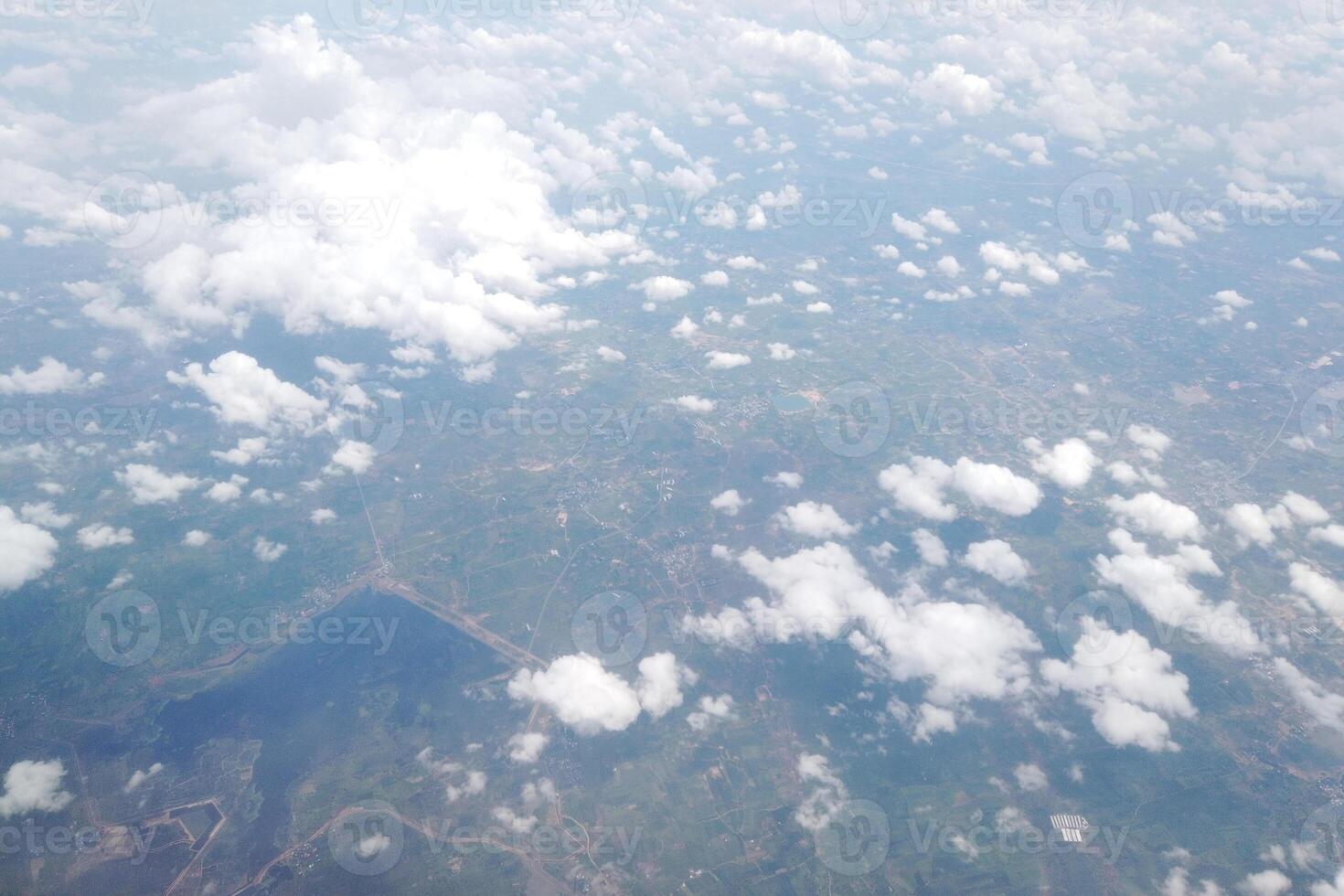 Aerial view of lush green landscape with clouds above rural area nature photography sky environment wide angle serenity photo