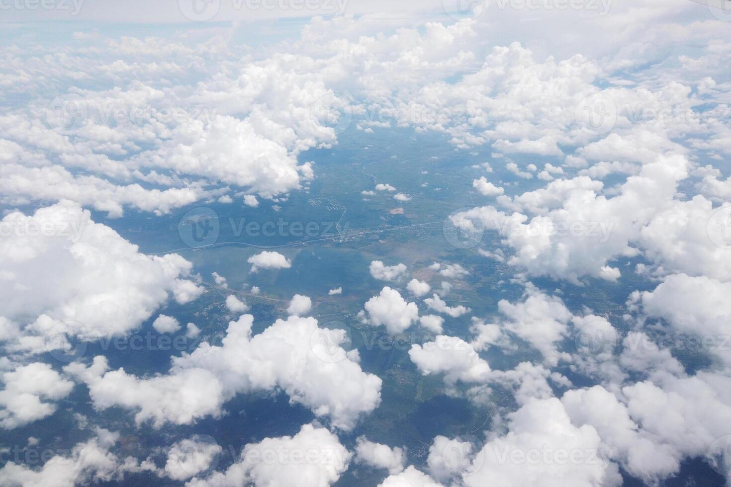 Aerial view of lush green landscapes and fluffy clouds above the earth nature photography serene atmosphere drone perspective nature's beauty photo