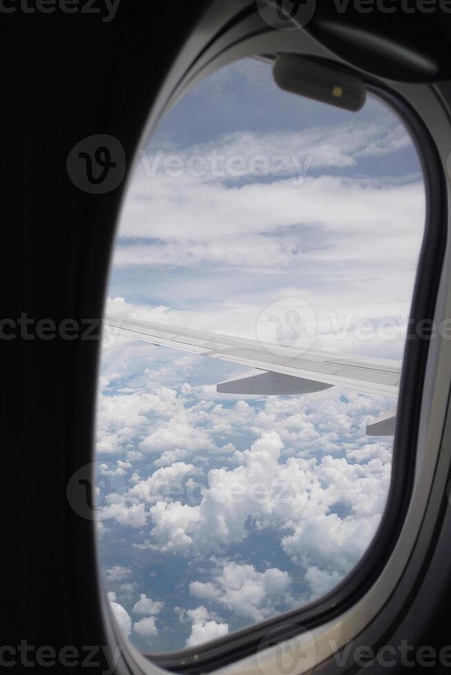 Aerial view of clouds and wing airplane journey travel experience sky environment passenger perspective adventure concept photo
