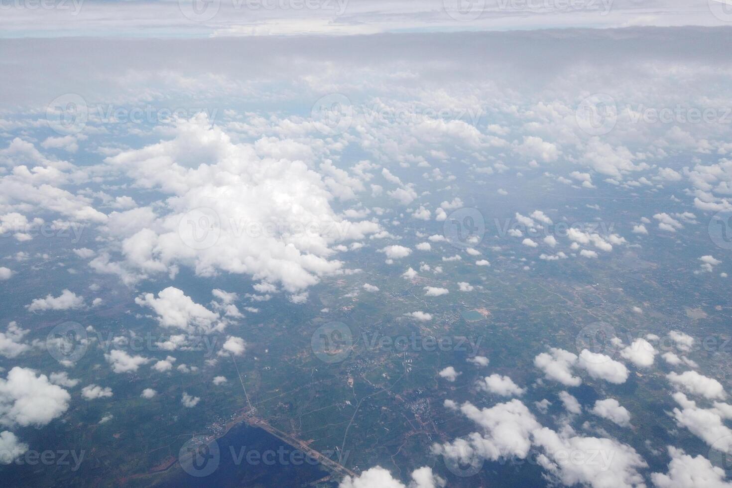 Aerial view of clouds over green landscapes scenic flight nature photography open sky breathtaking perspective photo