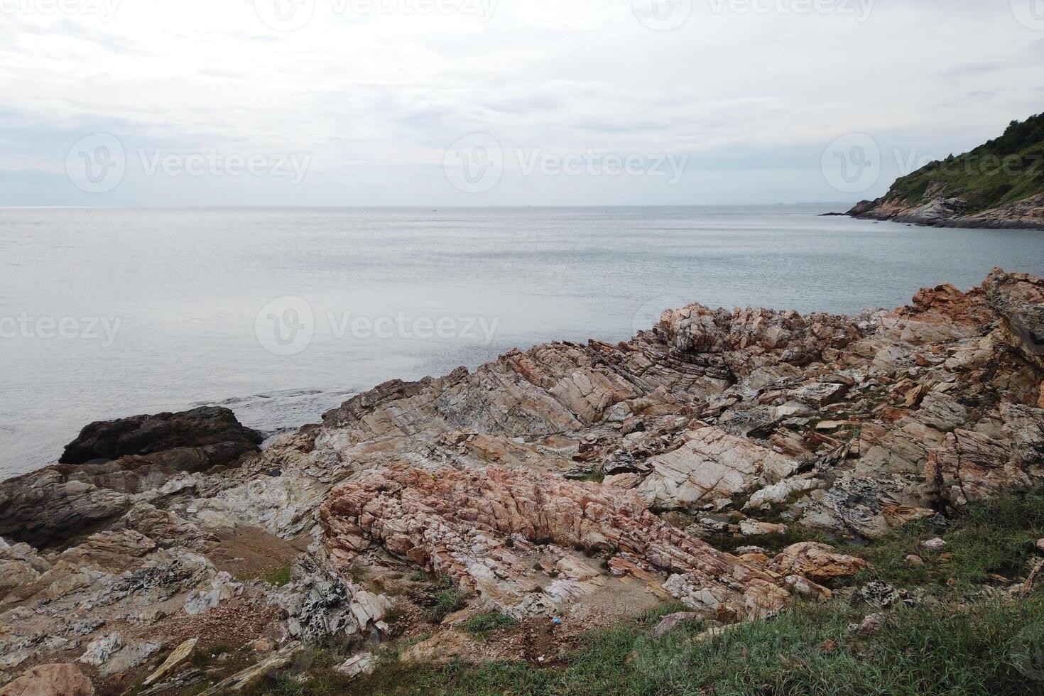 Coastal erosion action rocky shoreline seaside landscape calm waters natural setting environmental impact photo