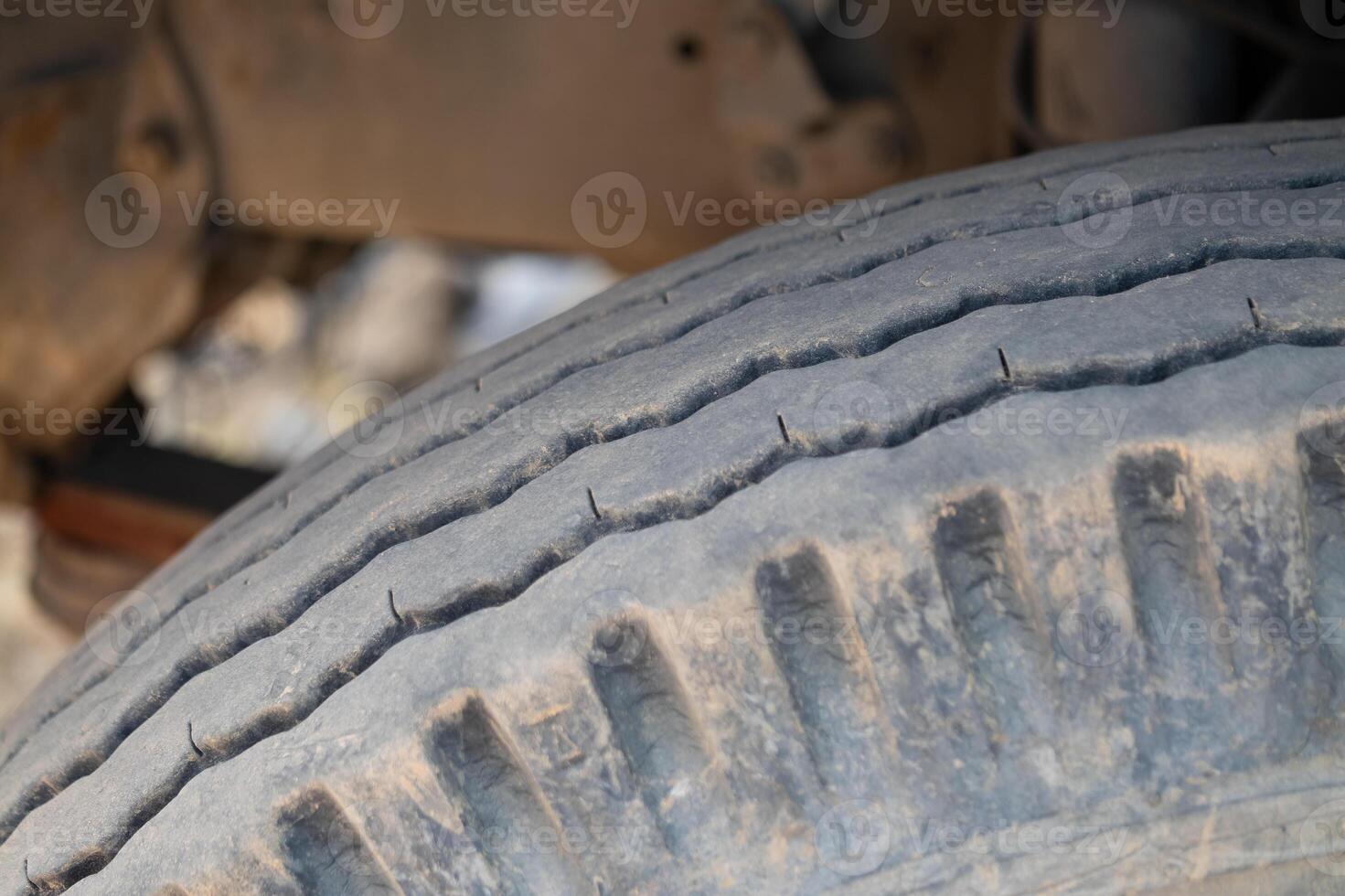 Inspecting worn tire garage photography industrial setting close-up view vehicle maintenance photo