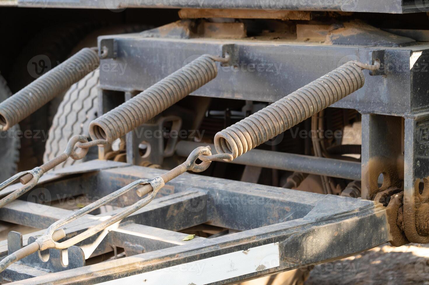 Truck suspension system close-up workshop mechanical detail industrial setting ground view engineering concepts photo