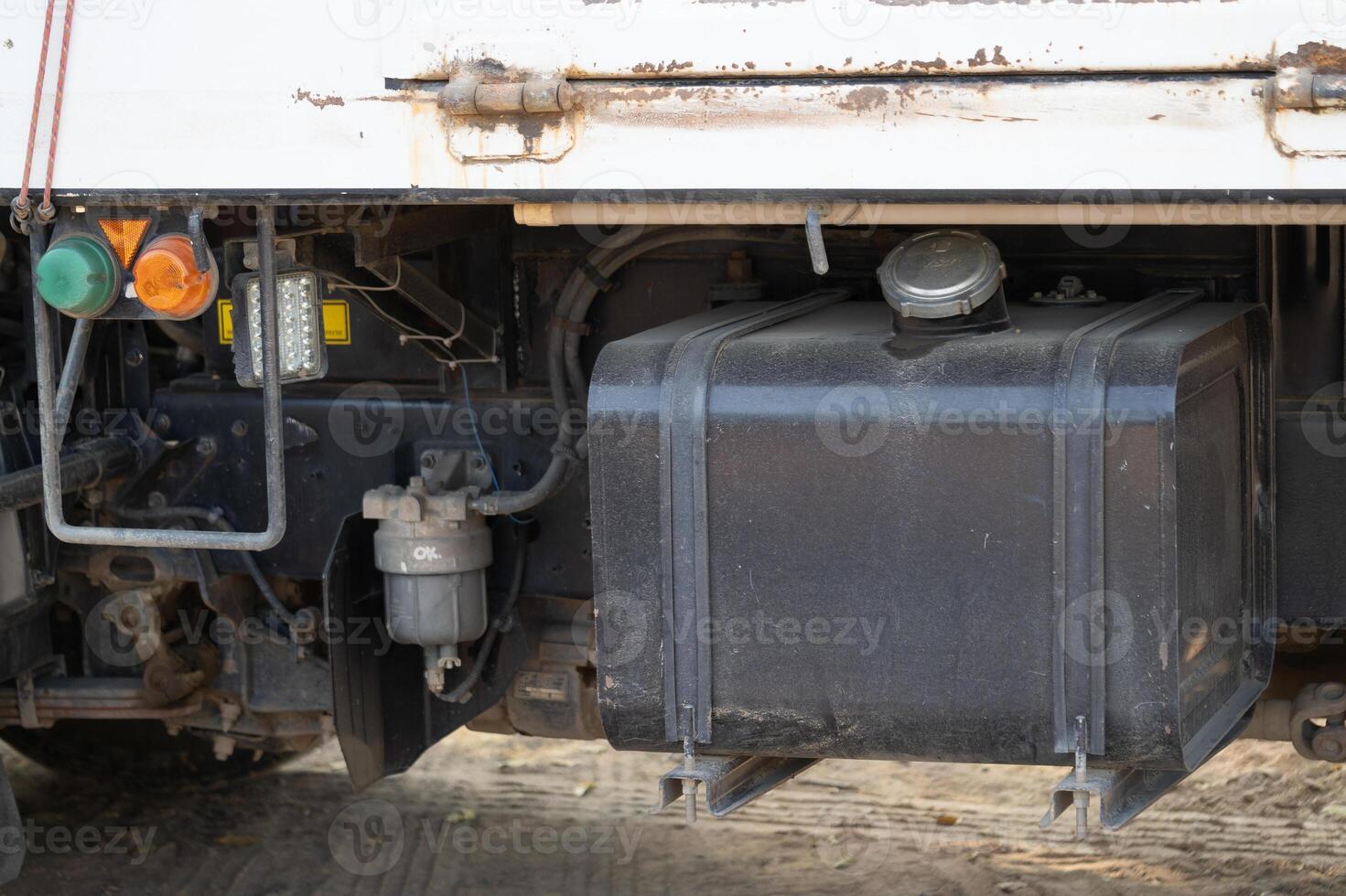 Fuel tank maintenance truck service area equipment close-up industrial environment side view vehicle repair photo