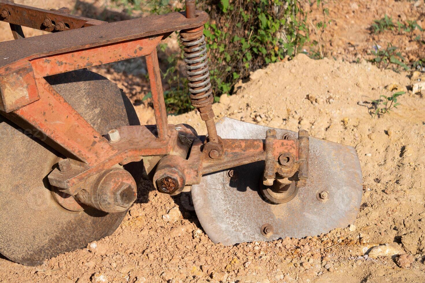 Plowing action on agricultural equipment farmland machinery detail rural setting close-up view farming concept photo