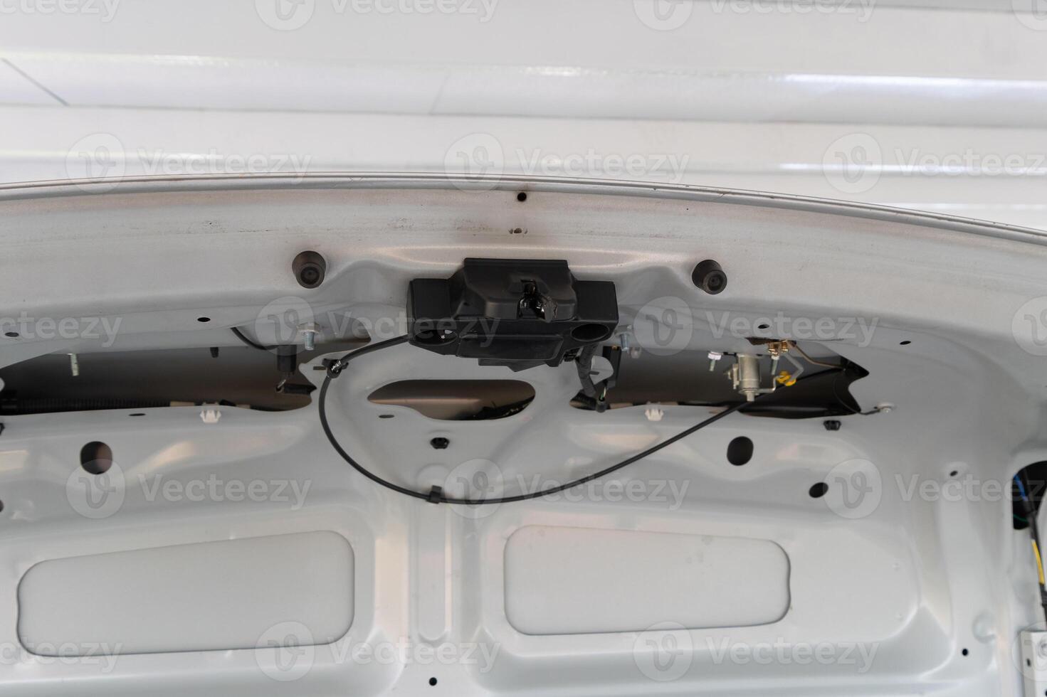 Vehicle maintenance action car trunk inspection automotive content indoor garage environment close-up viewpoint technical concept photo