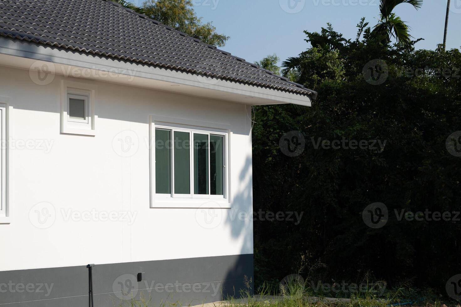 Newly constructed home exterior suburban area architectural photograph bright day side view modern design photo
