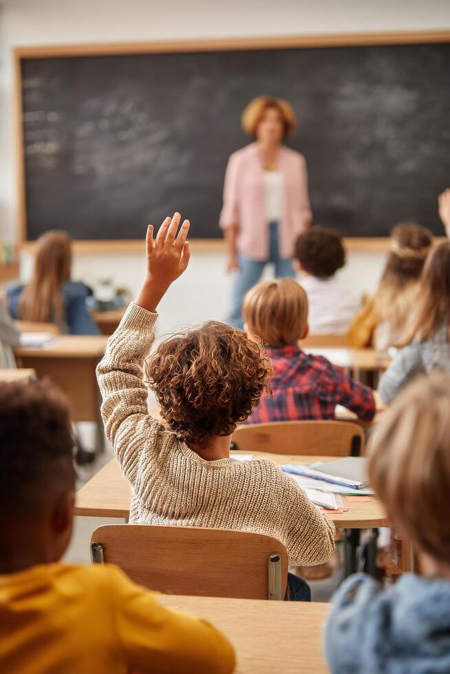 Students Engaged in Learning With Raised Hands in Classroom Setting photo