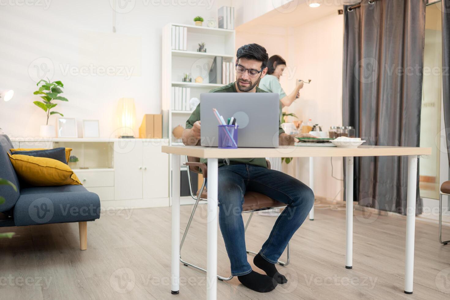 Portrait of a young freelancer smiling while working online via laptop at home with his girlfriend,309 photo