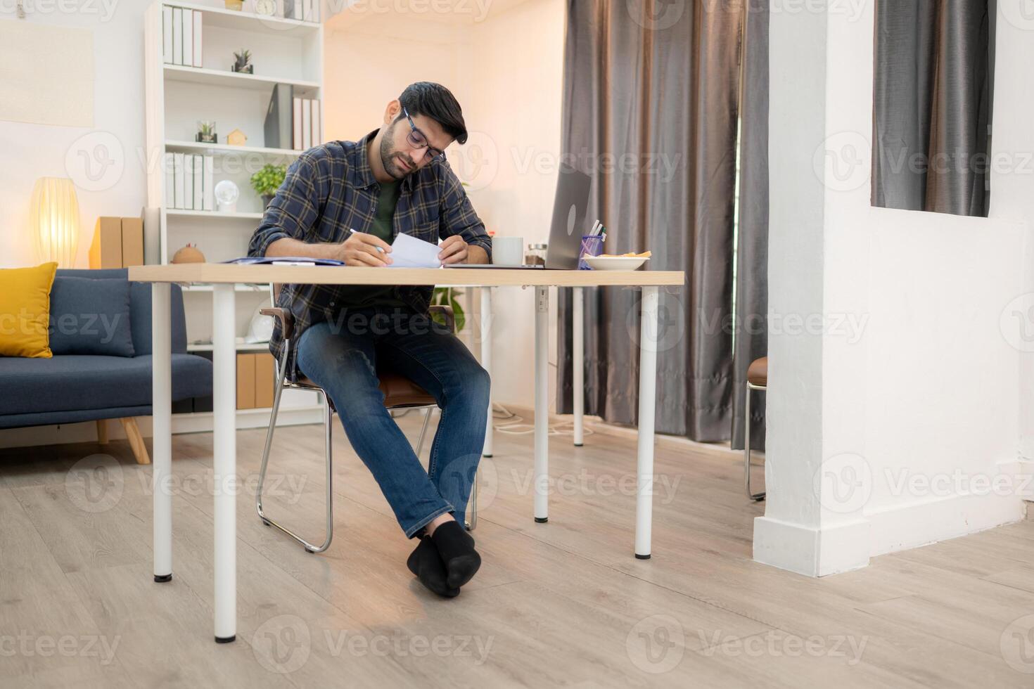 Portrait of a young freelancer smiling while working online via laptop at home with his girlfriend,293 photo