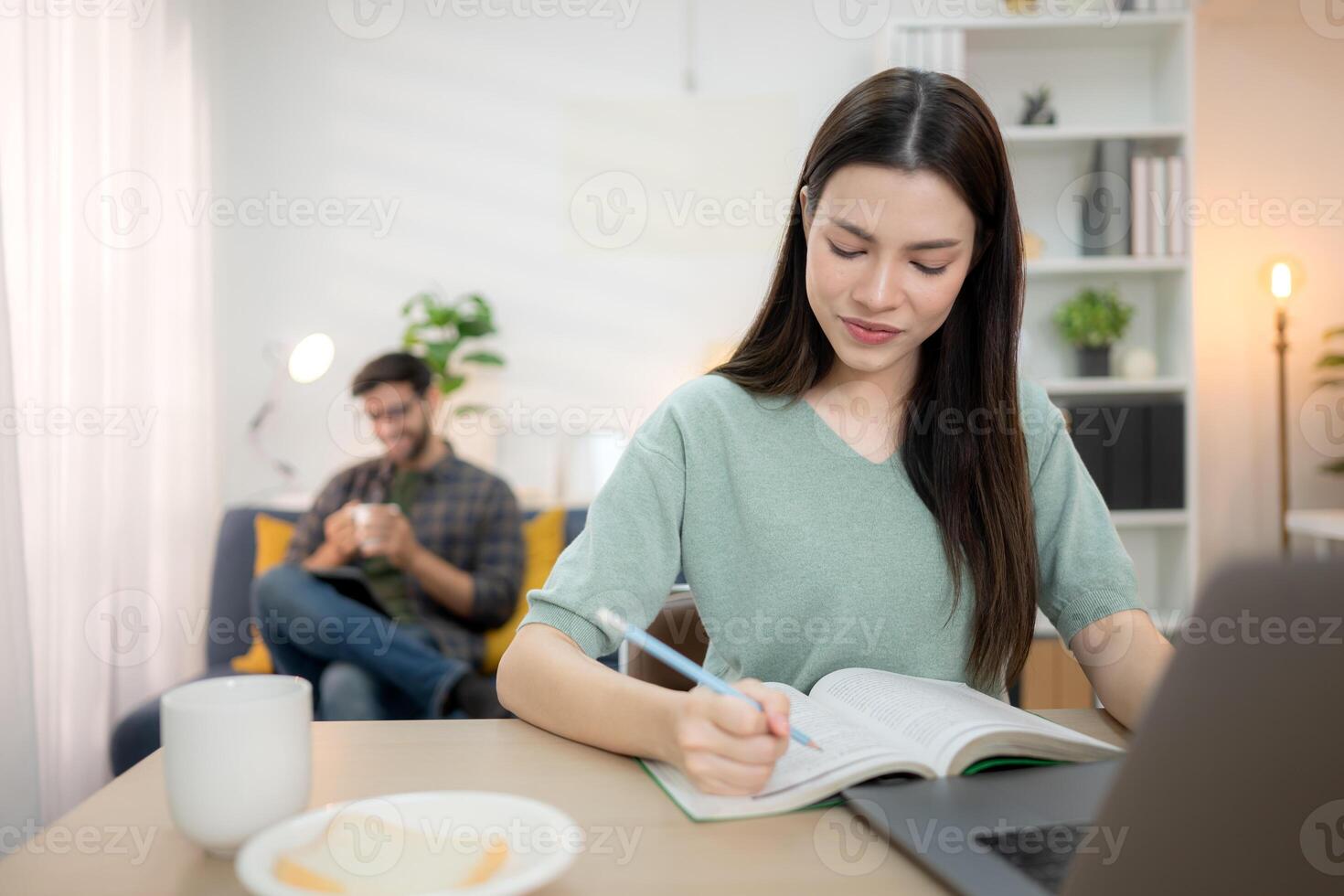 Portrait of a young freelancer smiling while working online via laptop at home with his boyfriend,263 photo