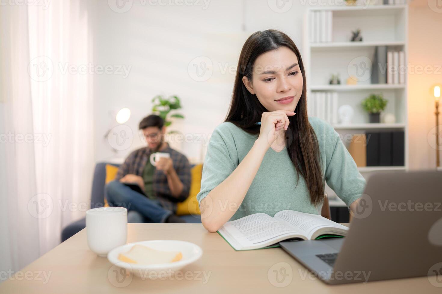 Portrait of a young freelancer smiling while working online via laptop at home with his boyfriend,256 photo