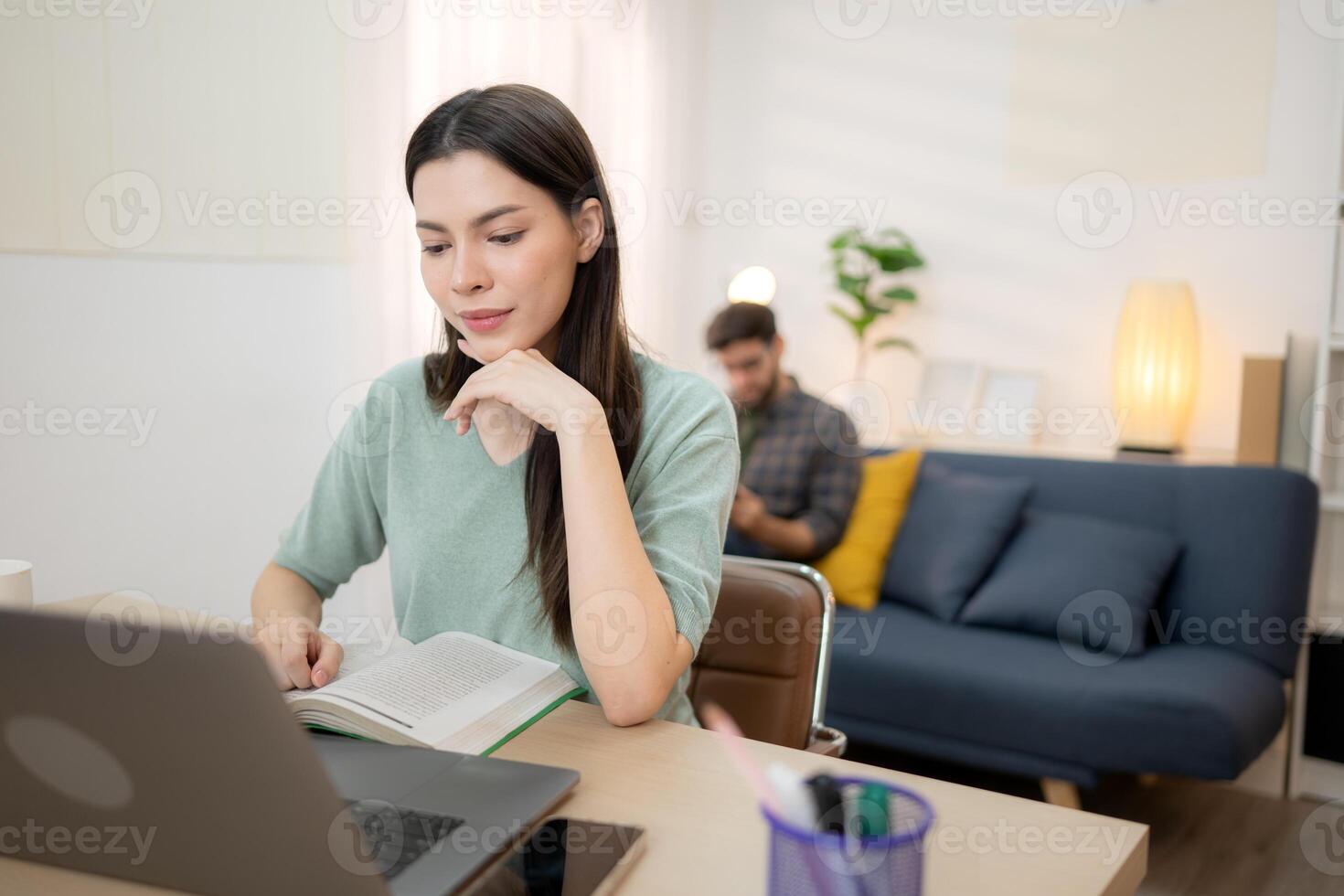 Portrait of a young freelancer smiling while working online via laptop at home with his boyfriend,254 photo