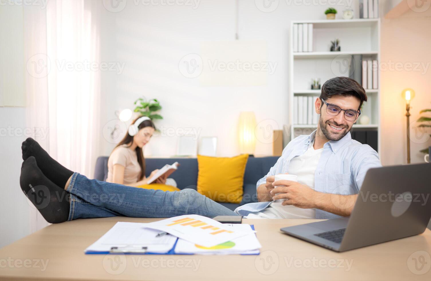 Portrait of a young freelancer smiling while working online via laptop at home with his girlfriend,167 photo