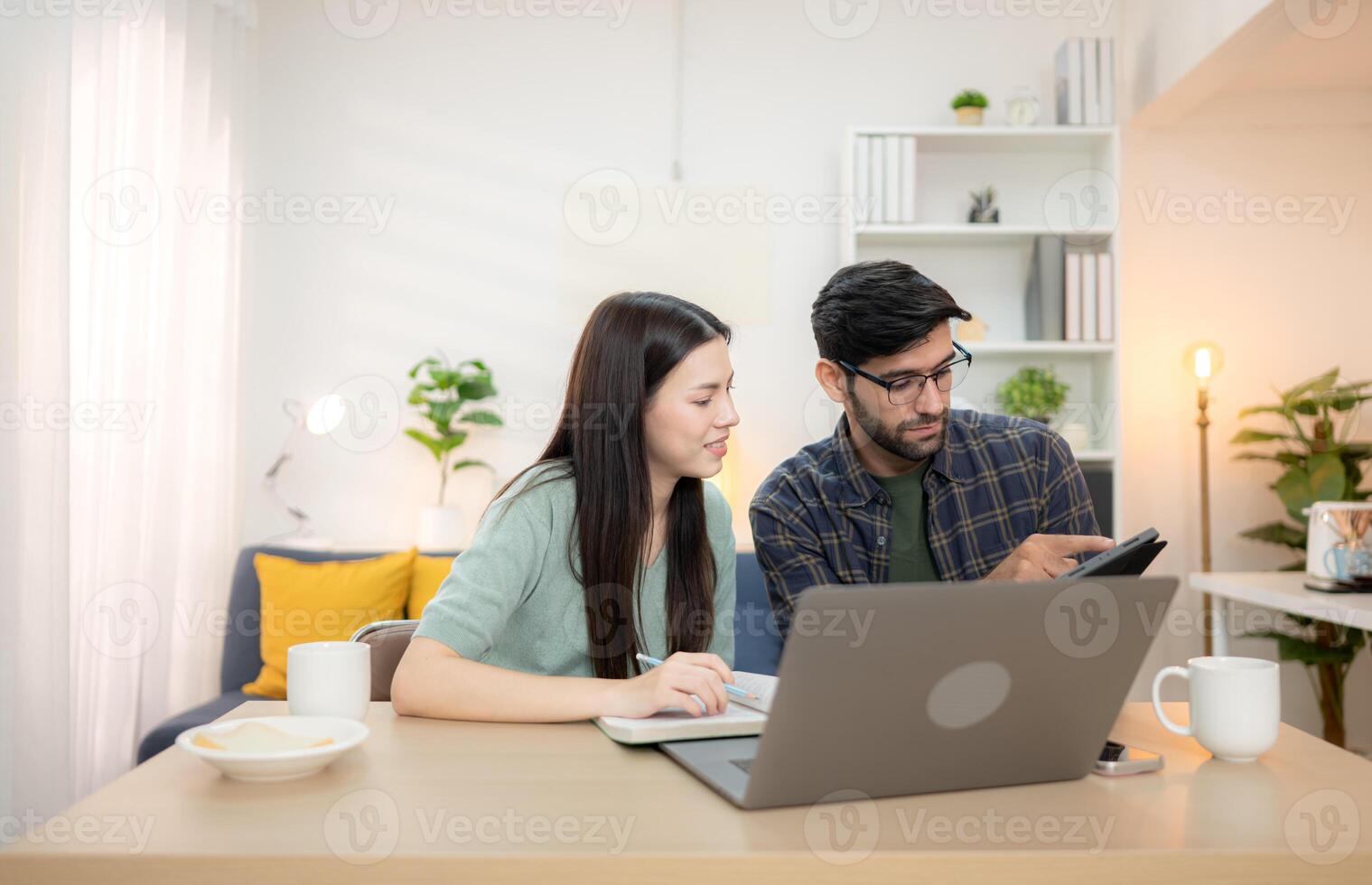 Portrait of a young freelancer smiling while working online via laptop at home with his boyfriend,162 photo