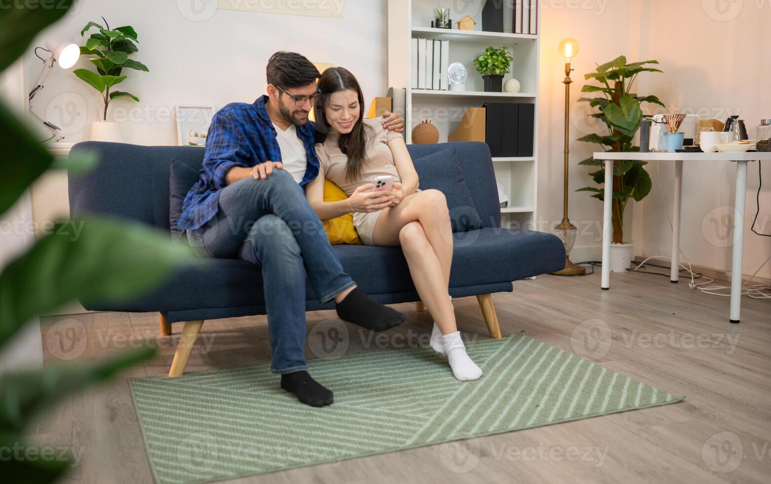 Young couple are smiling while relax and working online via laptop in living room at home,85 photo