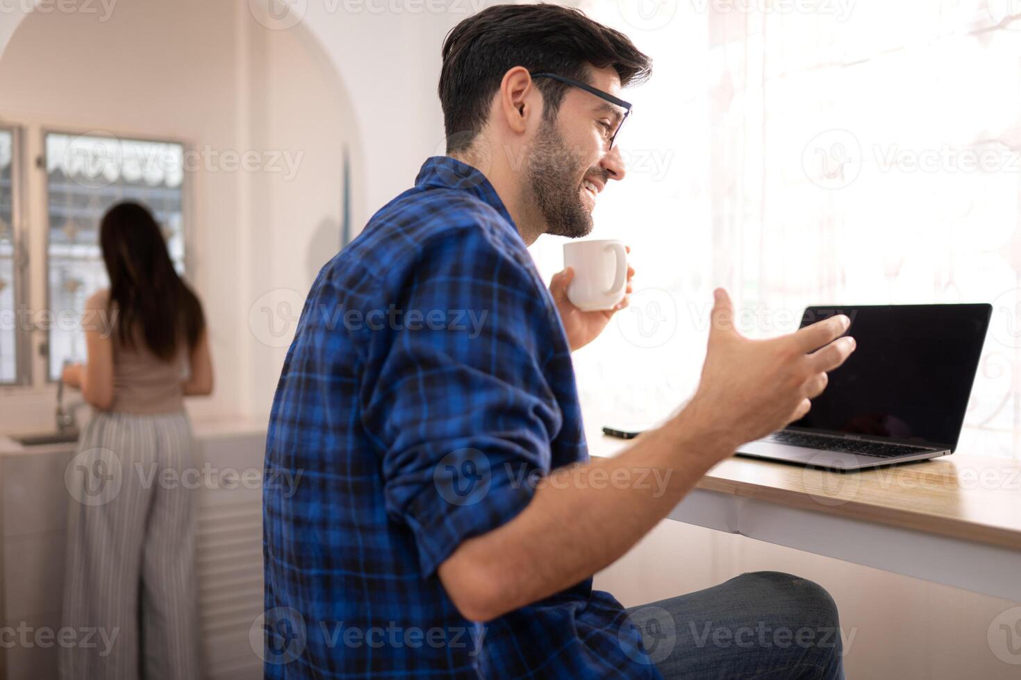 Portrait of a young freelancer smiling while working online via laptop at home with his girlfriend,83 photo