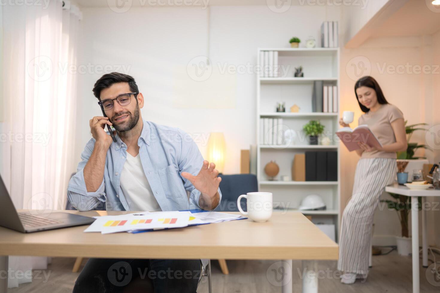 Portrait of a young freelancer smiling while working online via laptop at home with his girlfriend,75 photo
