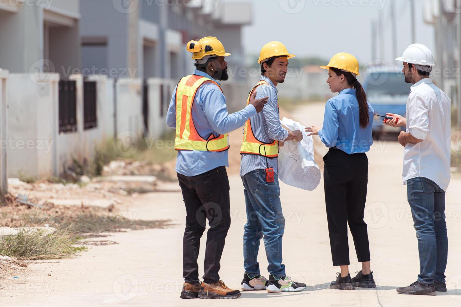 Group of architects and engineers work together to assess the residential home construction site's progress,163 photo
