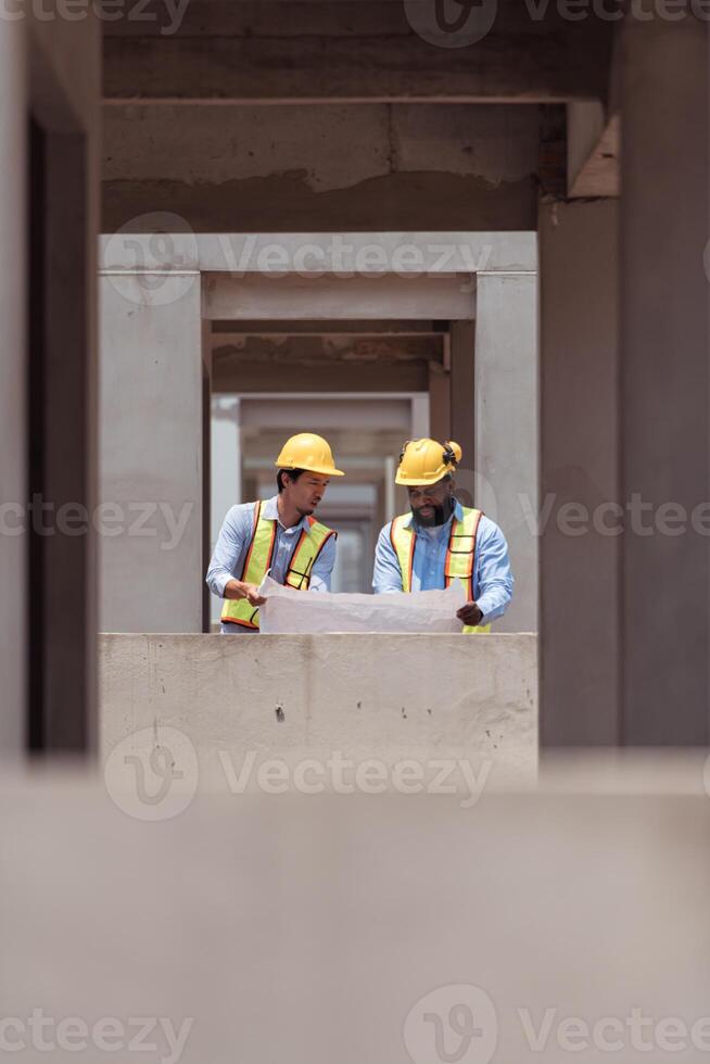 Architects and engineers work together to assess the residential home construction site's progress,105 photo
