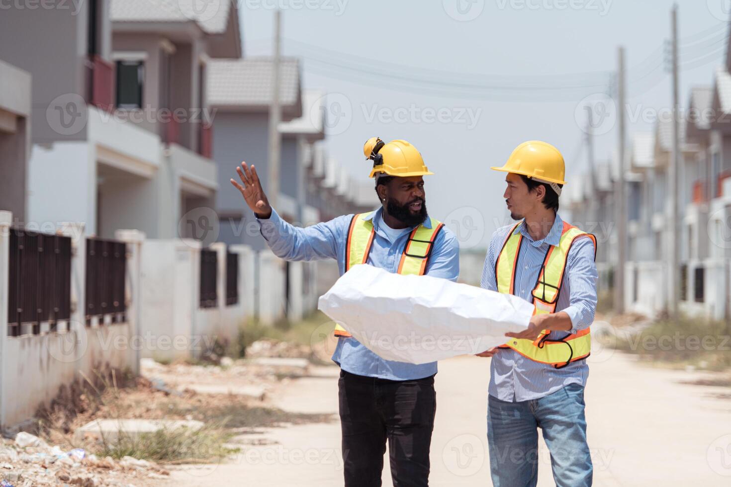 Architects and engineers work together to assess the residential home construction site's progress,83 photo