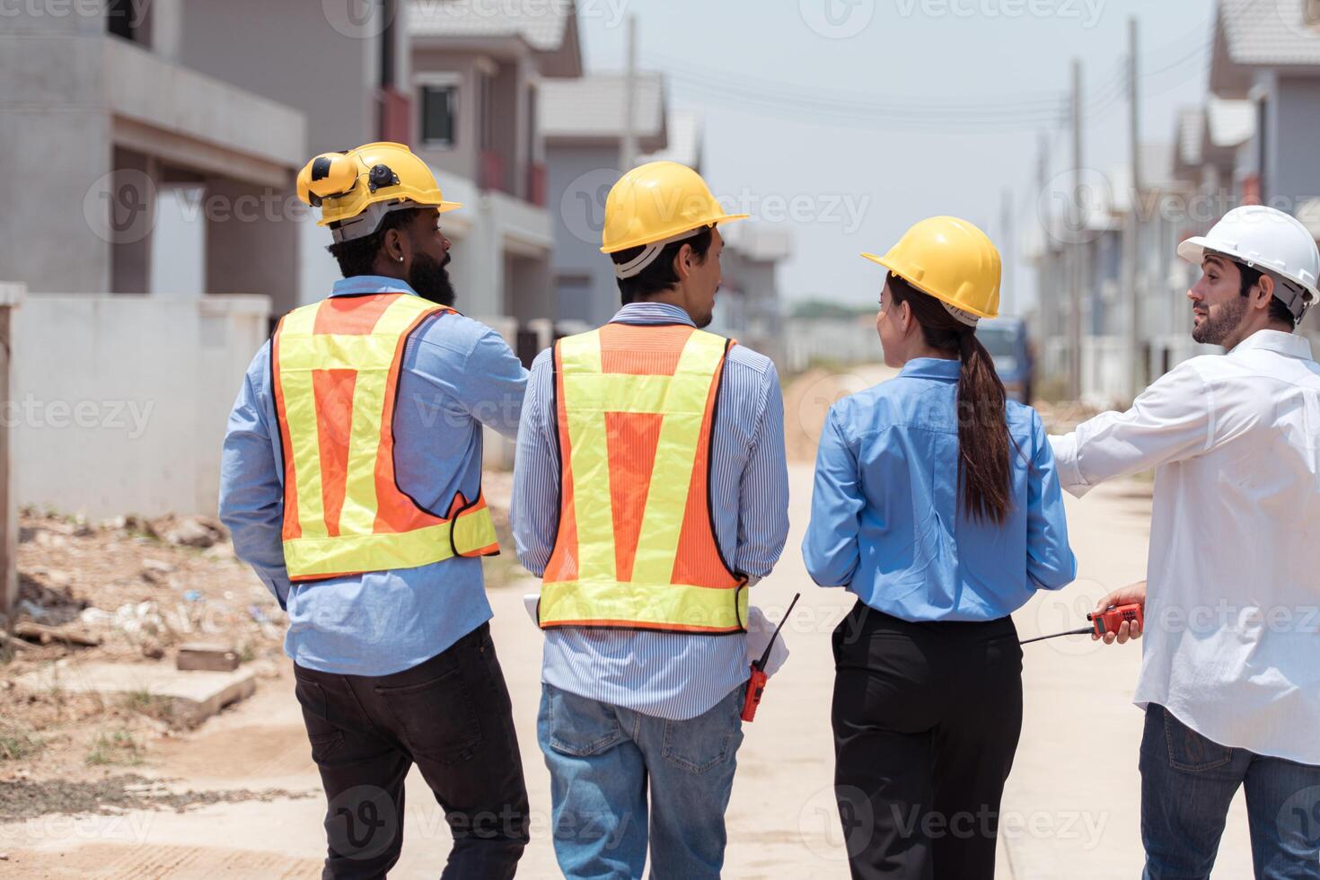 Group of architects and engineers work together to assess the residential home construction site's progress,44 photo
