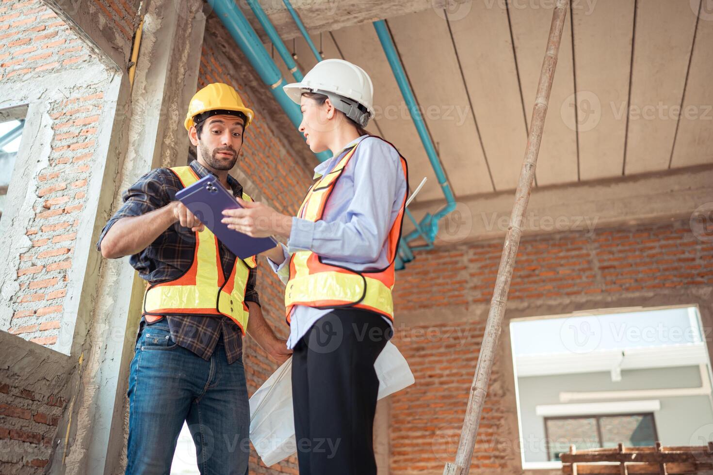 Architects and engineers work together to assess the residential home construction site's progress,35 photo