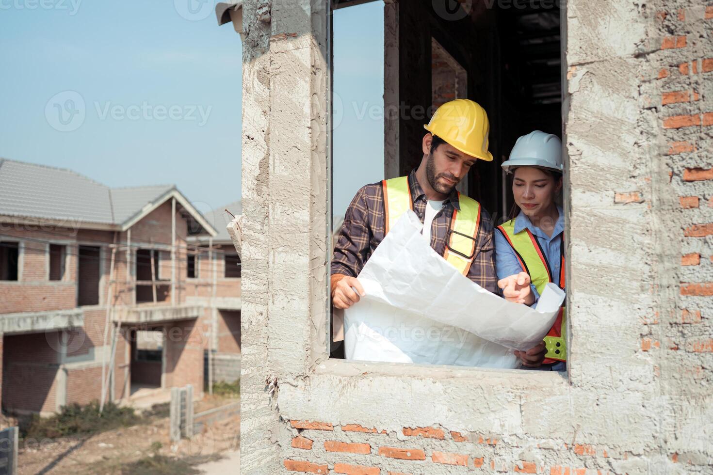 Architects and engineers work together to assess the residential home construction site's progress,24 photo