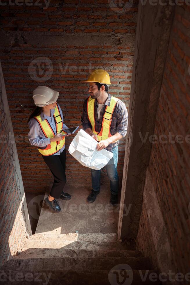 Architects and engineers work together to assess the residential home construction site's progress,13 photo
