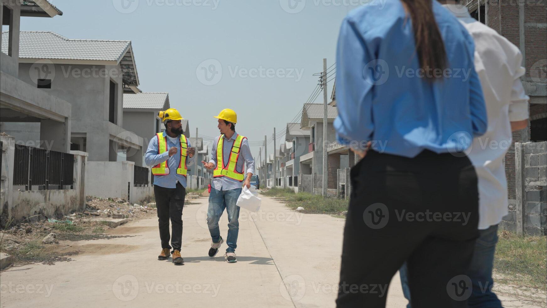 Group of architects and engineers work together to assess the residential home construction site's progress,268 photo