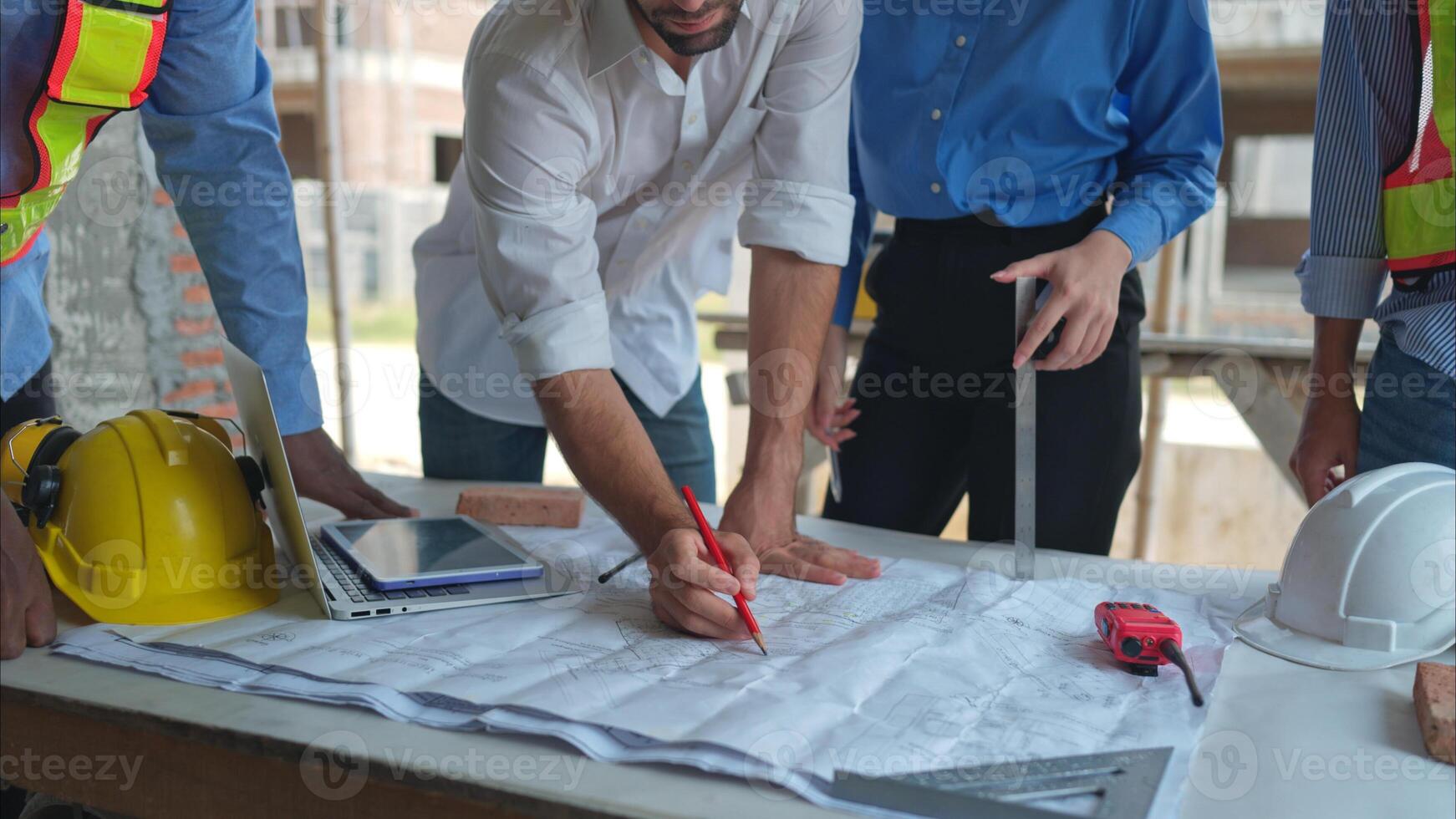 Group of architects and engineers work together to assess the residential home construction site's progress,266 photo