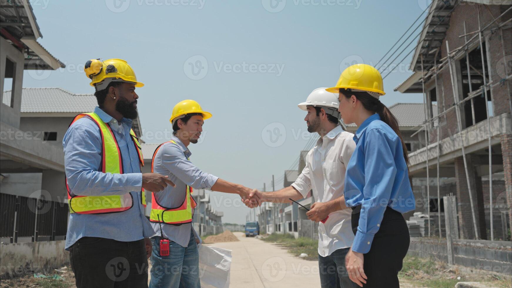 Group of architects and engineers work together to assess the residential home construction site's progress,253 photo