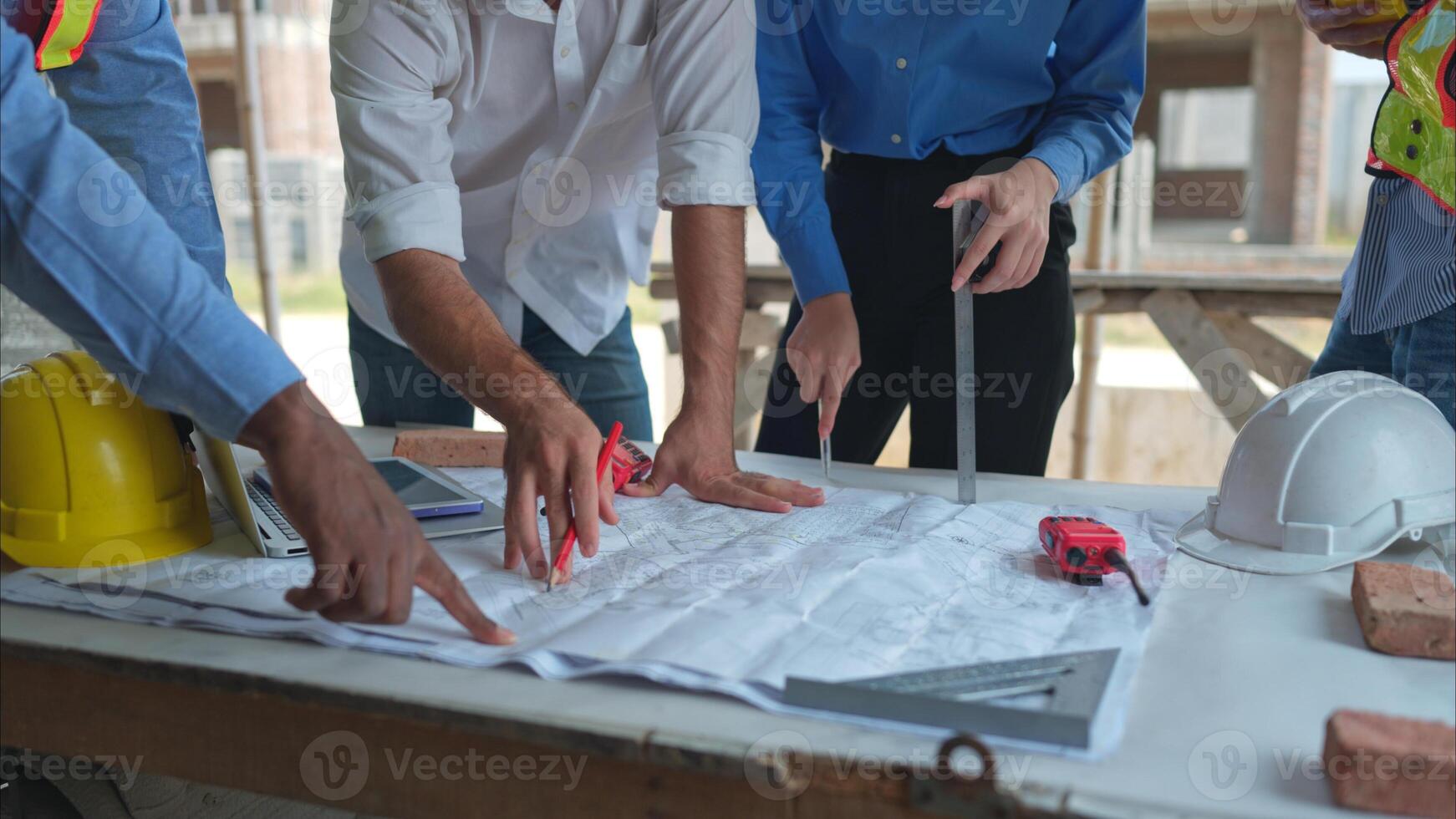 Group of architects and engineers work together to assess the residential home construction site's progress,244 photo