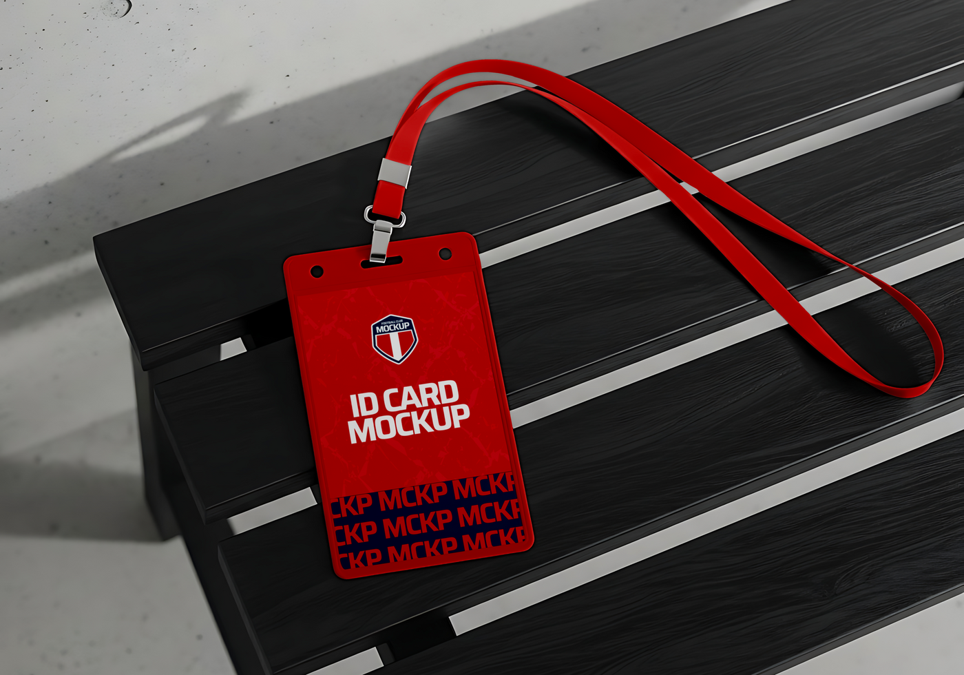A red ID card mockup with a lanyard rests on a black bench psd
