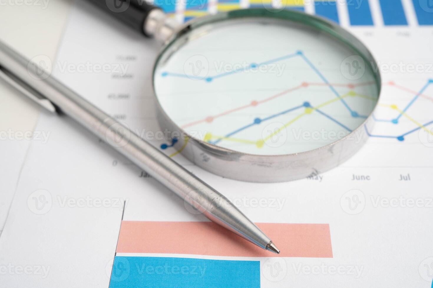 Magnifying glass on charts graphs paper. Financial development, Banking Account, Statistic, Investment Analytic research data photo
