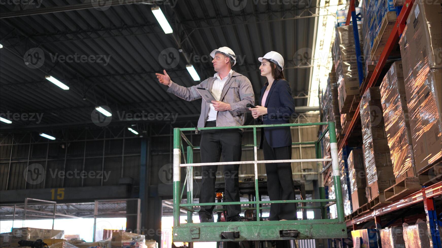 Business woman and warehouse workers are reviewing the list of items based on the documentation,84 photo