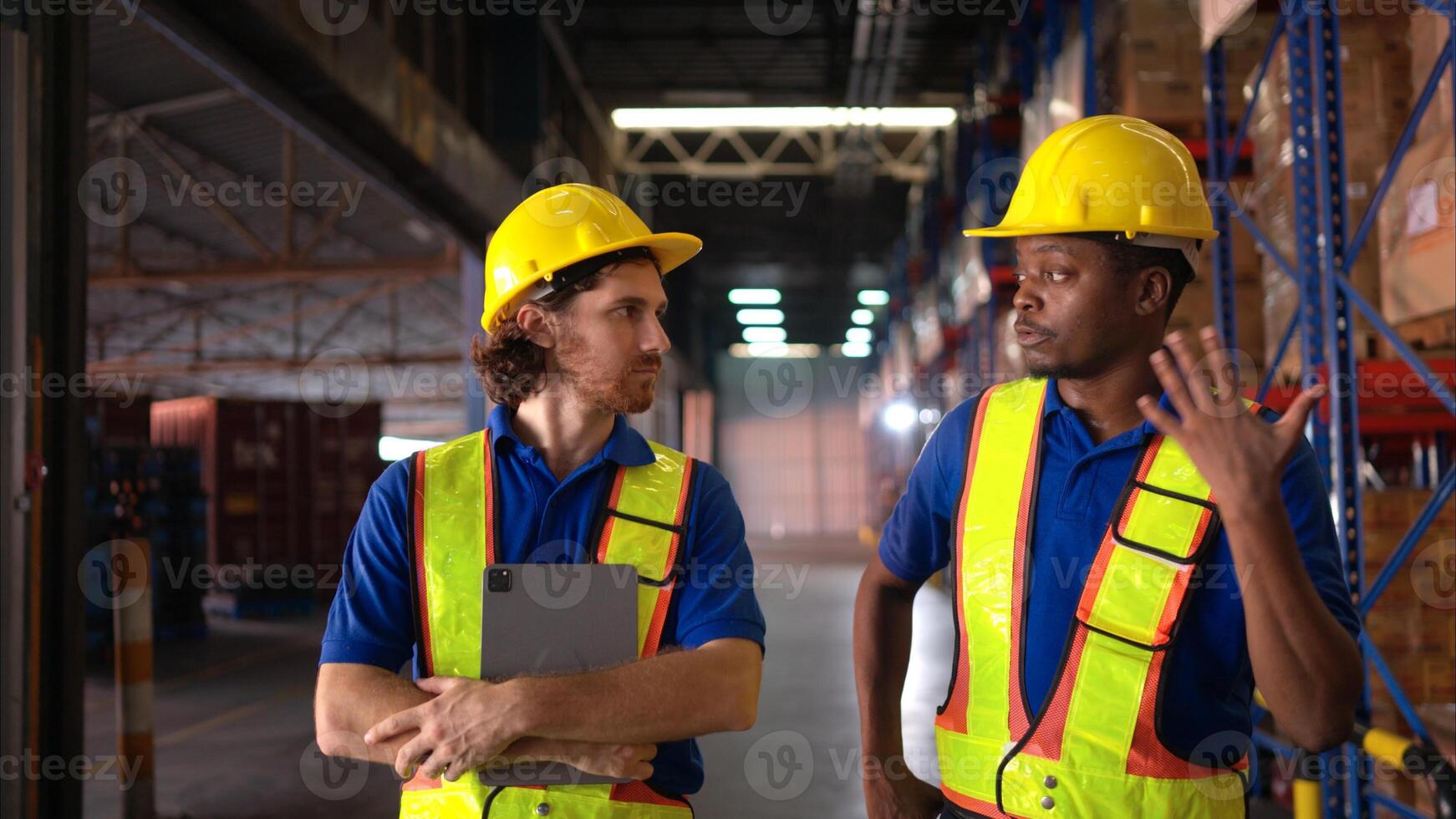 A bunch of warehouse workers are reviewing the list of items based on the documentation,78 photo