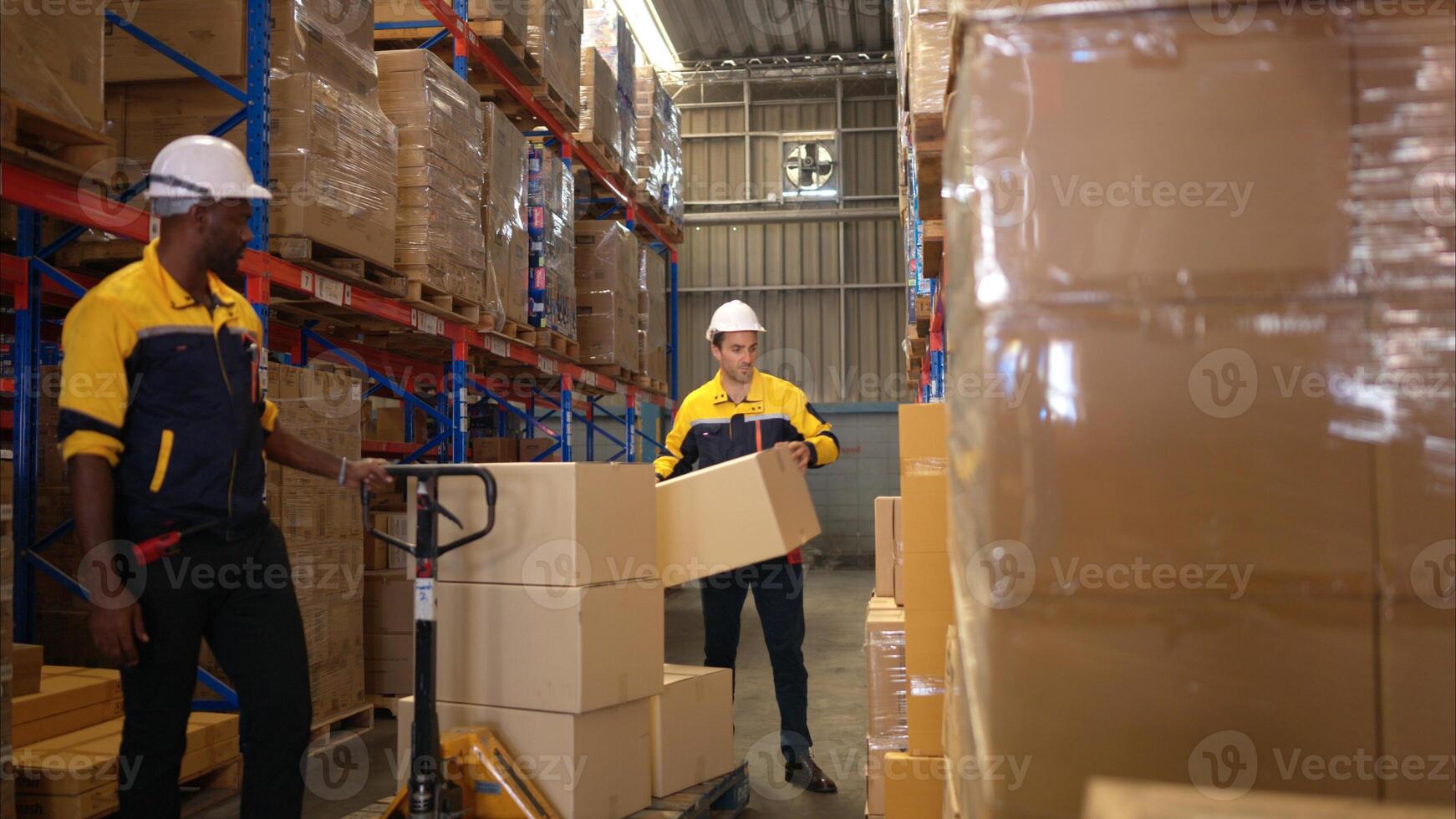 Two warehouse workers are lifting boxes of merchandise on a pallet jack to store on a shelf in a warehouse,69 photo