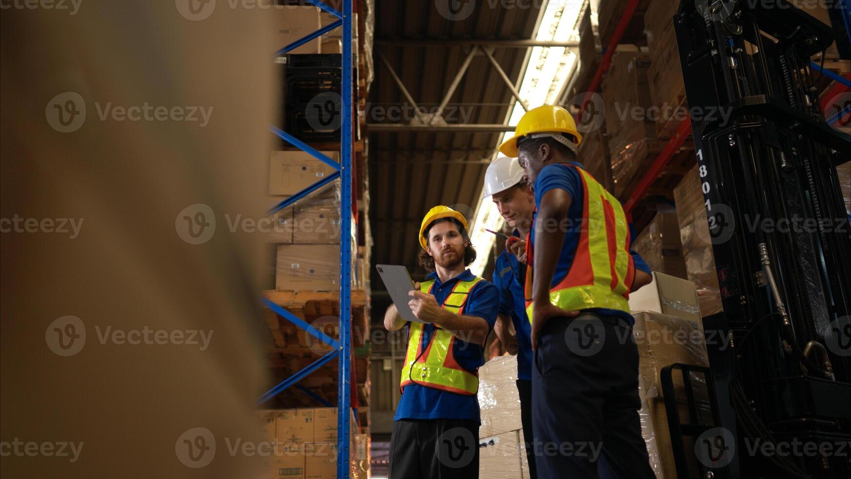 A bunch of warehouse workers are reviewing the list of items based on the documentation,58 photo