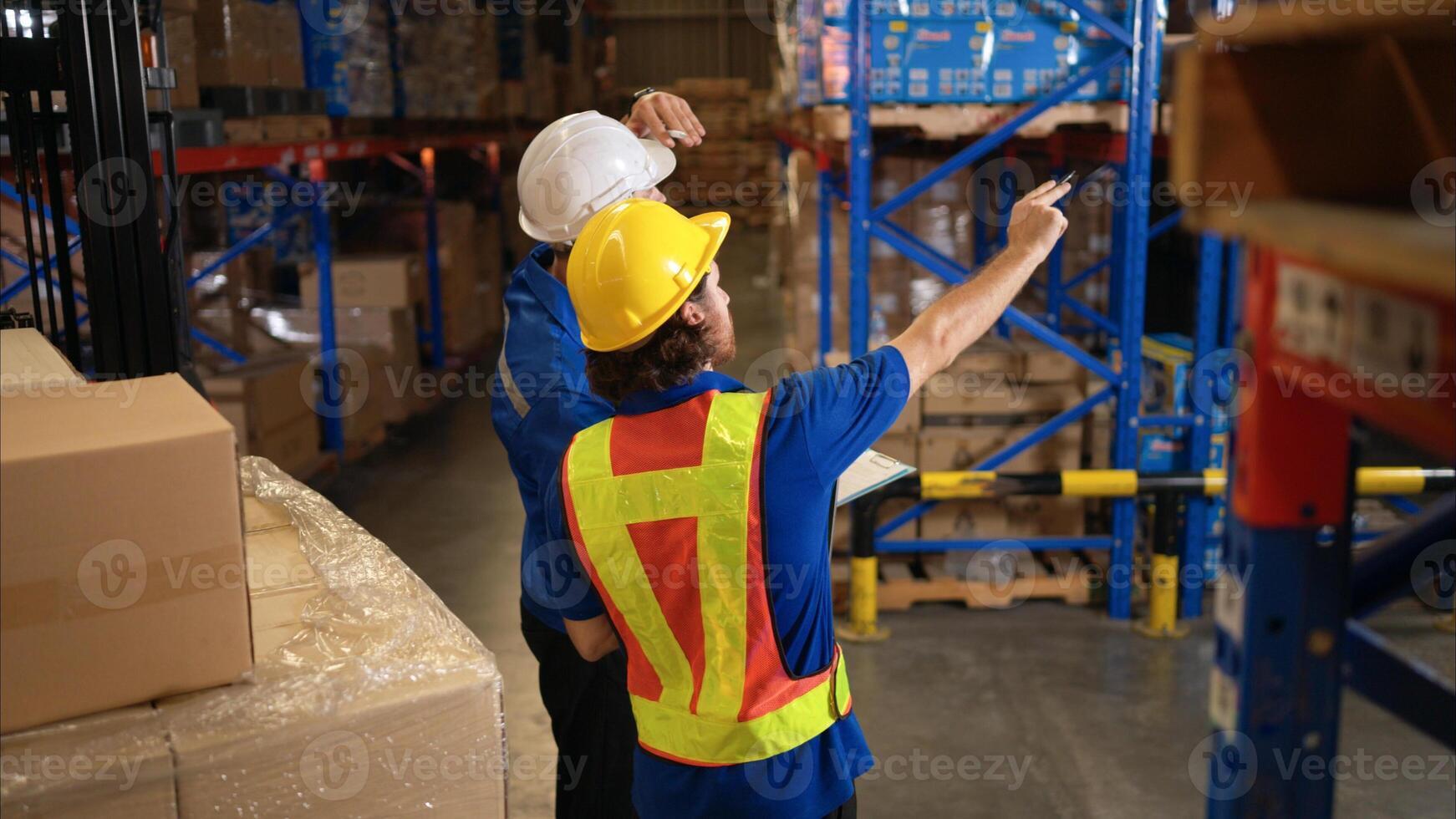 A bunch of warehouse workers are reviewing the list of items based on the documentation,46 photo