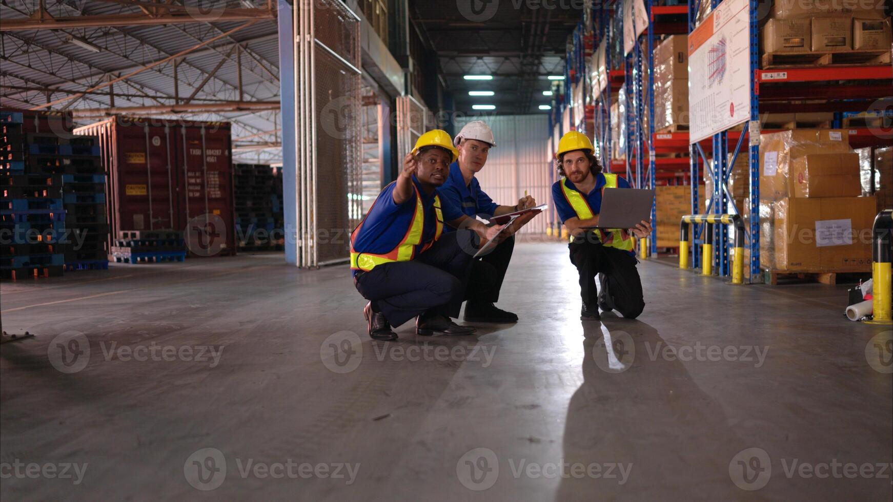 A bunch of warehouse workers are reviewing the list of items based on the documentation,10 photo