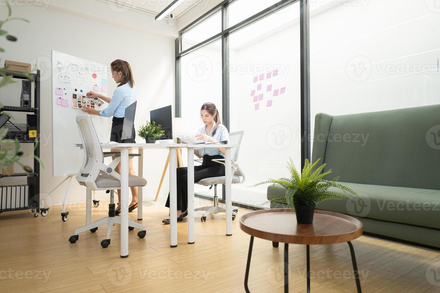 In a contemporary office, two young woman entrepreneurs are on a mission to generate ideas,184 photo