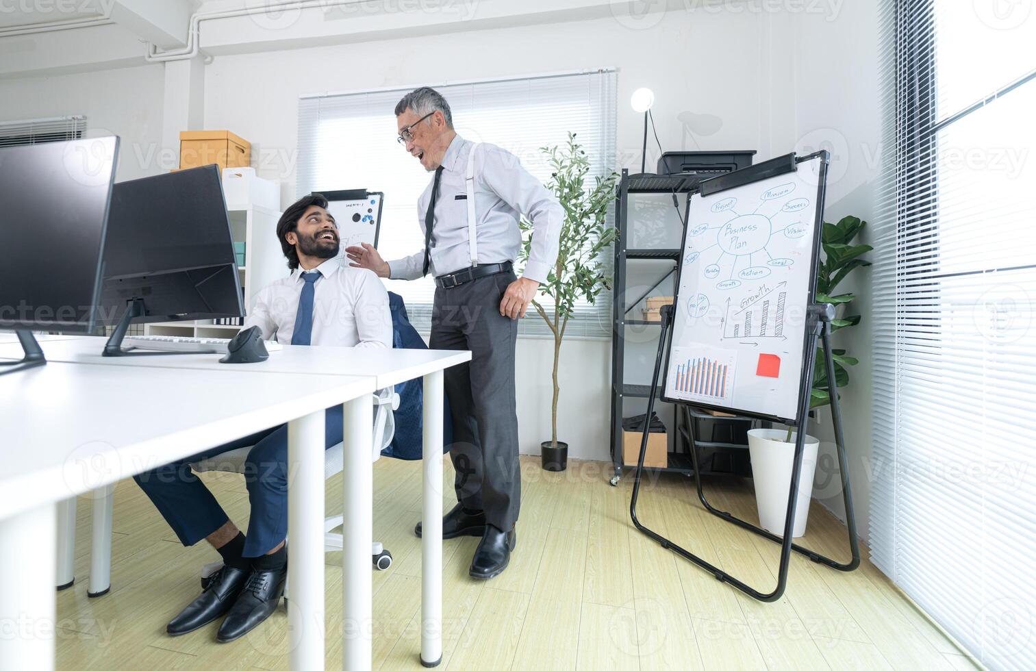 In a contemporary office, two senior executives with a mission to brainstorm and monitor,99 photo