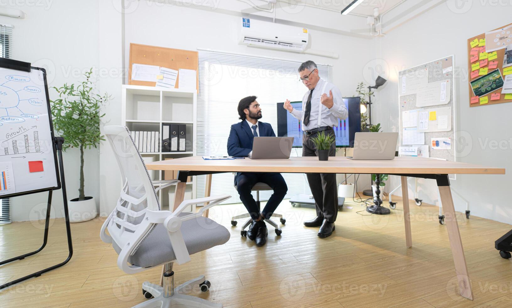 In a contemporary office, two senior executives with a mission to brainstorm and monitor,96 photo