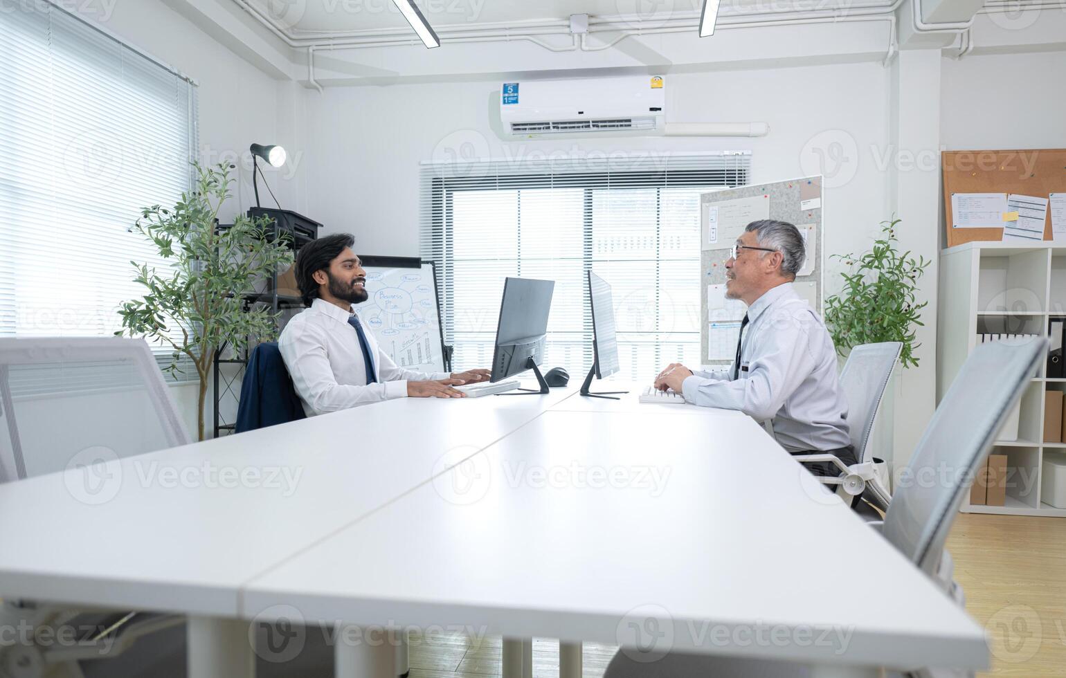 In a contemporary office, two senior executives with a mission to brainstorm and monitor,90 photo