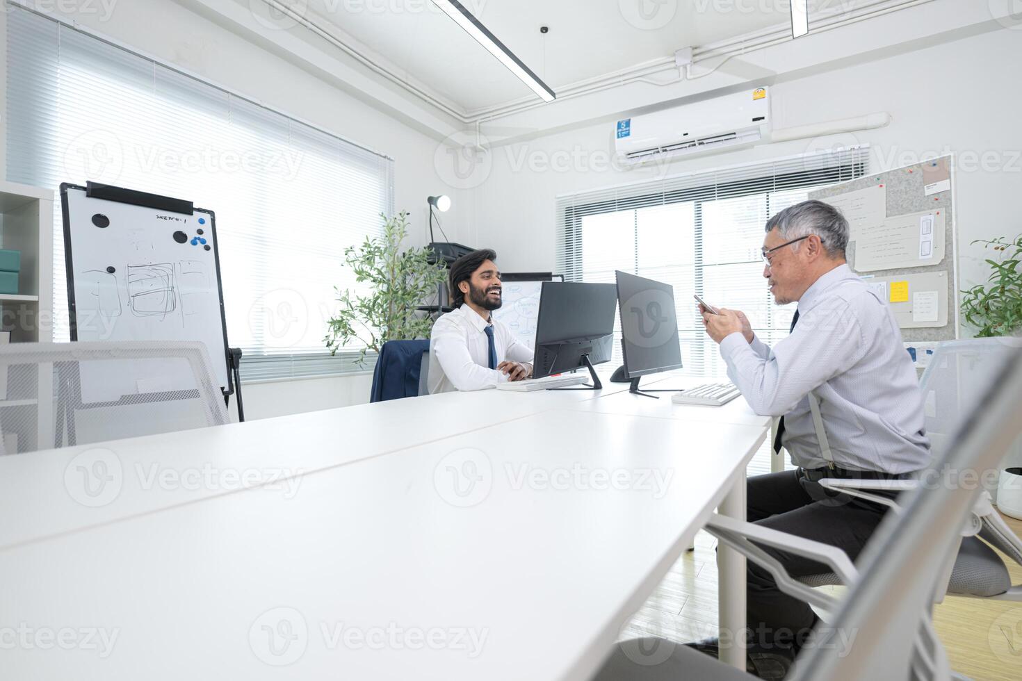In a contemporary office, two senior executives with a mission to brainstorm and monitor,88 photo