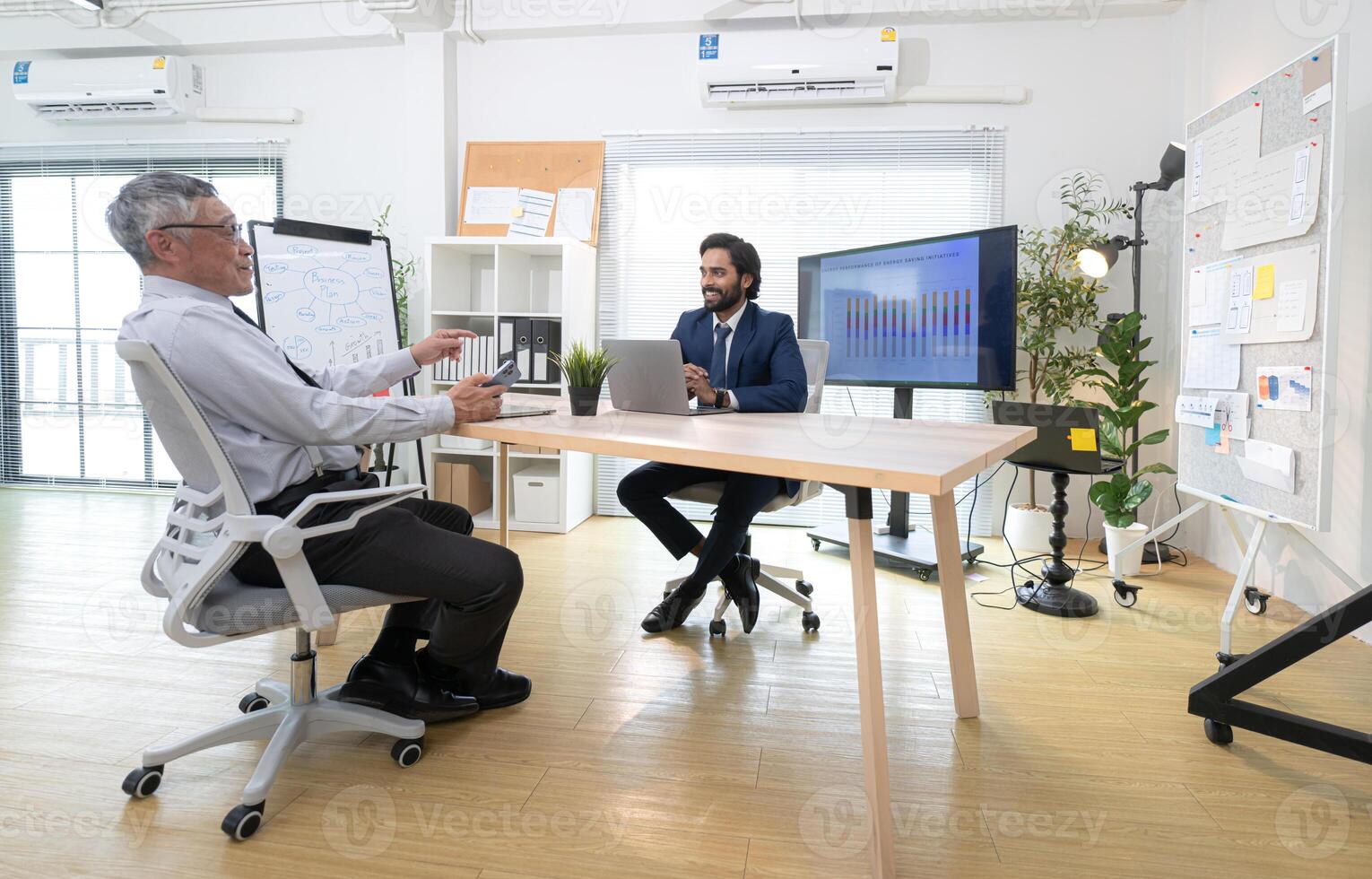 In a contemporary office, two senior executives with a mission to brainstorm and monitor,80 photo