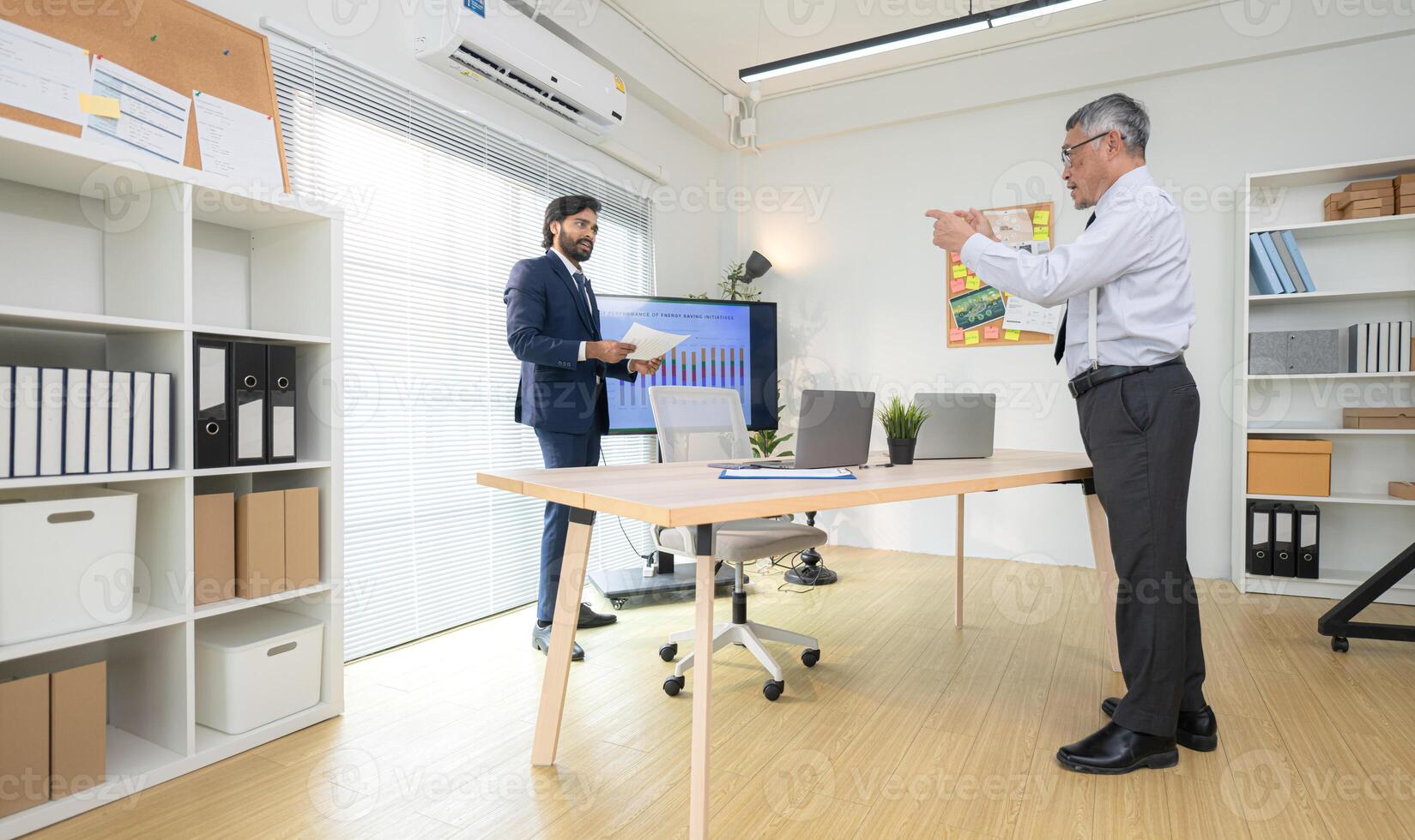 In a contemporary office, two senior executives with a mission to brainstorm and monitor,79 photo