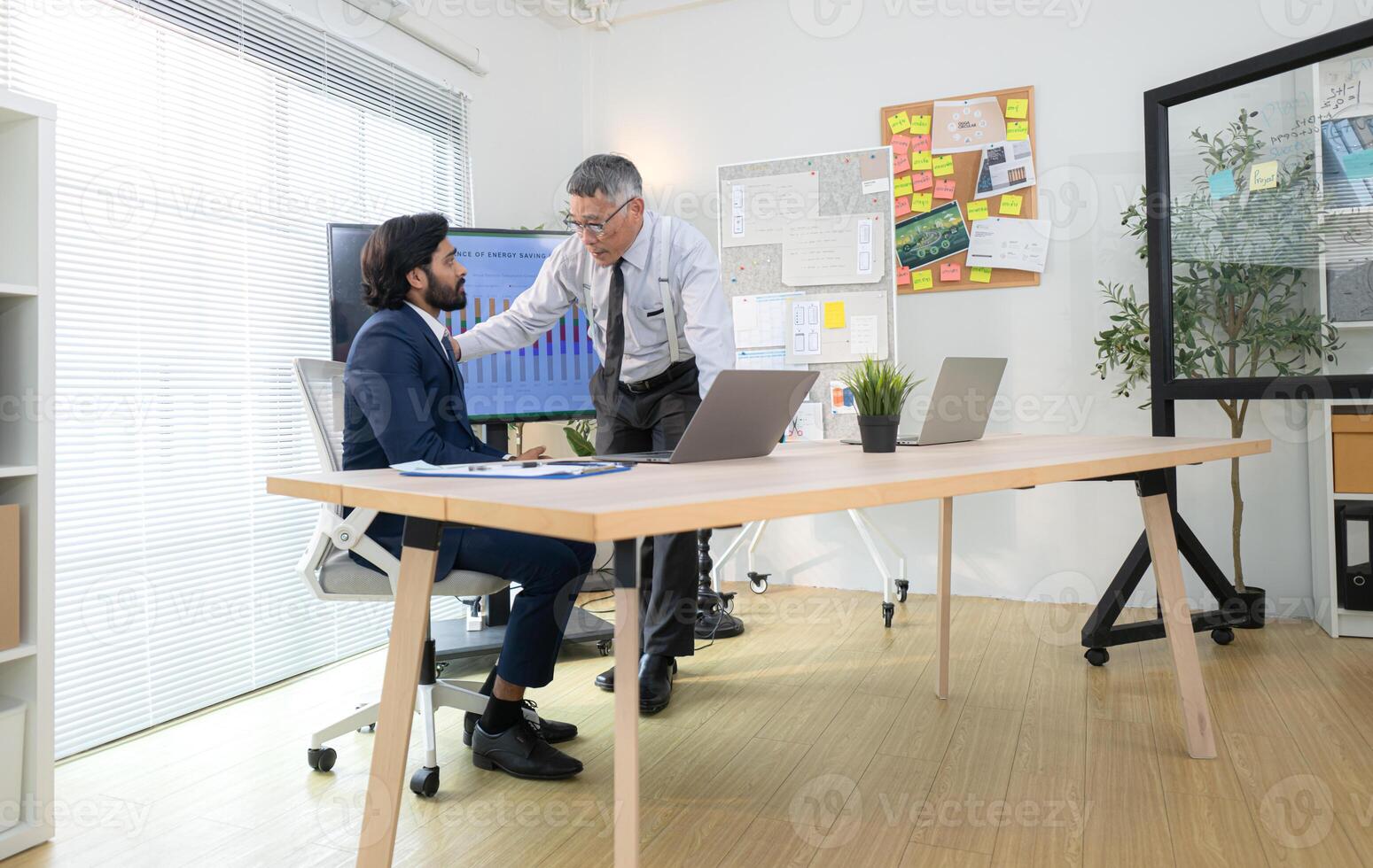 In a contemporary office, two senior executives with a mission to brainstorm and monitor,78 photo